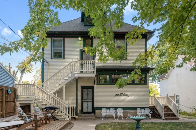 2523 Dupont Ave N, Minneapolis, MN 55411 - back of house with a deck, stairway, and roof with shingles