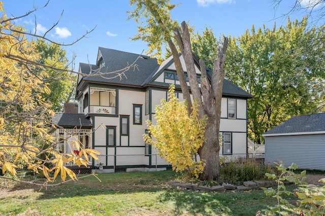 rear view of house featuring a lawn