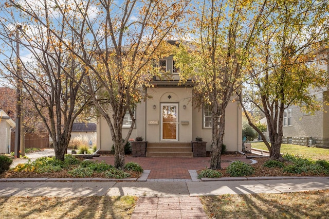 view of front of home with fence and stucco siding