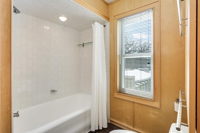 bathroom with toilet and shower / bath combo