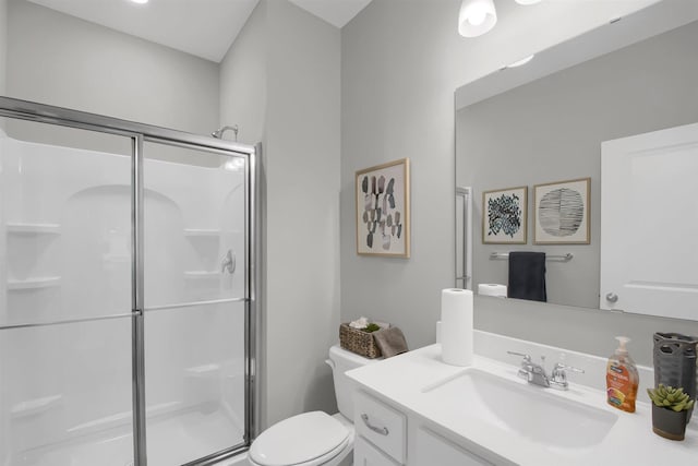 bathroom featuring an enclosed shower, vanity, and toilet