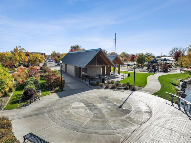 view of home's community featuring a playground and a lawn