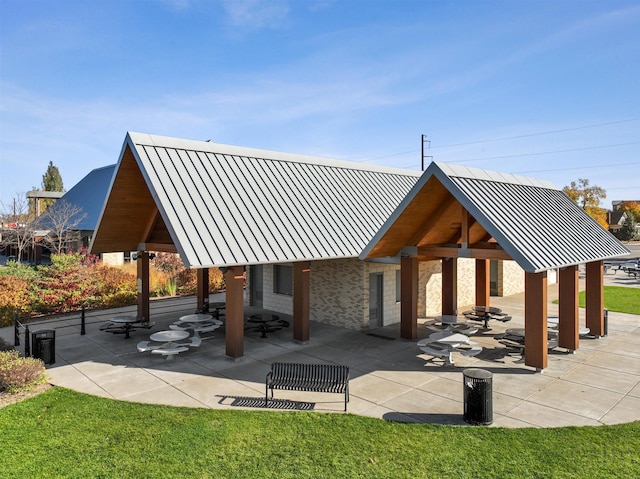 view of property's community featuring a gazebo, a patio, and a lawn