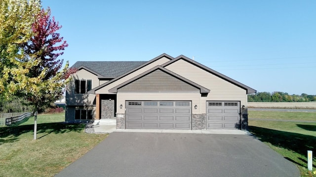 view of front facade with a front yard and a garage