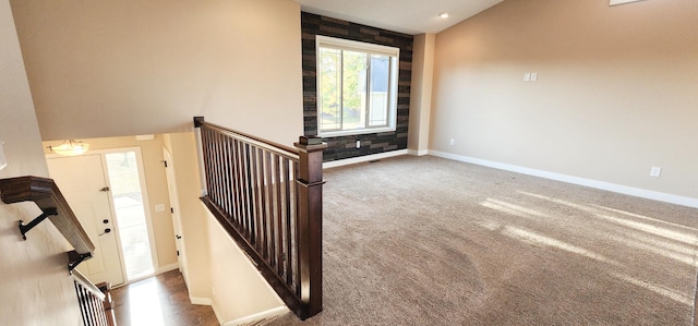 stairway with carpet flooring and lofted ceiling