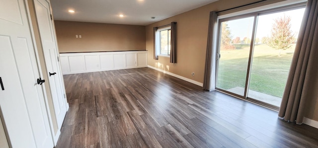 empty room with dark hardwood / wood-style floors