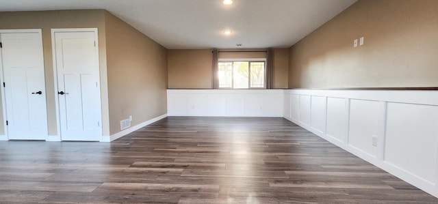 empty room with dark wood-type flooring