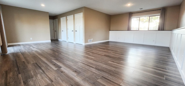 unfurnished room with dark wood-type flooring