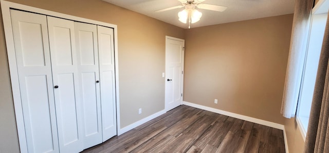 unfurnished bedroom with a closet, ceiling fan, and dark hardwood / wood-style floors