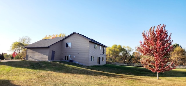 view of side of home featuring a yard