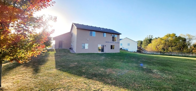 rear view of property with a lawn