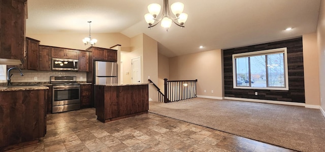 kitchen with vaulted ceiling, carpet floors, stainless steel appliances, decorative light fixtures, and a center island