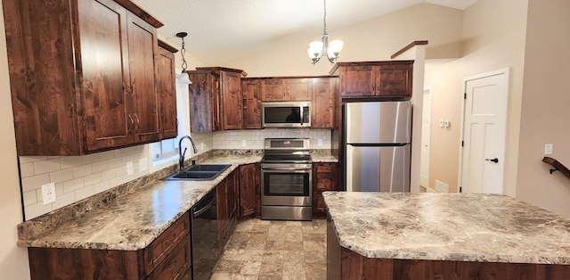 kitchen featuring light stone countertops, sink, appliances with stainless steel finishes, vaulted ceiling, and decorative light fixtures