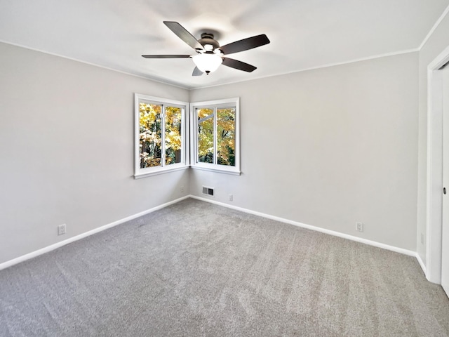 unfurnished room featuring ceiling fan, crown molding, and carpet floors