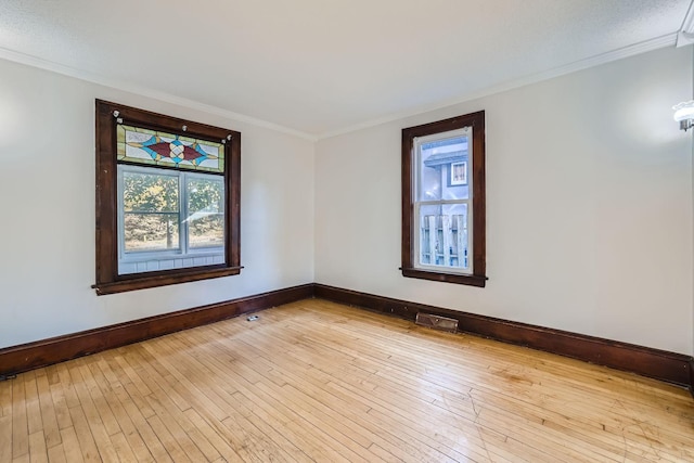 unfurnished room with crown molding and light hardwood / wood-style flooring