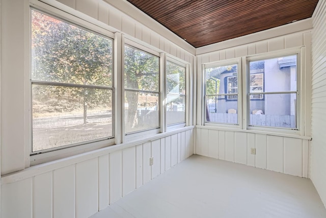 unfurnished sunroom featuring wood ceiling