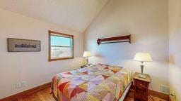 bedroom with lofted ceiling and hardwood / wood-style floors