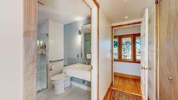 bathroom featuring wood-type flooring and toilet