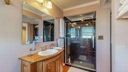 bathroom featuring vanity, ornamental molding, and decorative columns