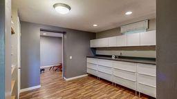 interior space with white cabinets and light hardwood / wood-style flooring