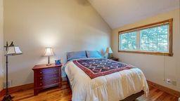 22735 Hickory Rd, Lanesboro, MN 55949 - bedroom with vaulted ceiling, wood finished floors, and baseboards