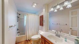 22735 Hickory Rd, Lanesboro, MN 55949 - bathroom featuring toilet, vanity, and shower / bath combo with shower curtain