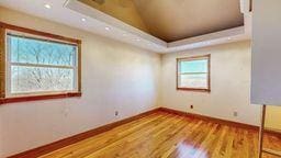 22735 Hickory Rd, Lanesboro, MN 55949 - unfurnished room with wood finished floors, baseboards, a raised ceiling, and recessed lighting