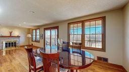 22735 Hickory Rd, Lanesboro, MN 55949 - dining space featuring wood finished floors and a fireplace