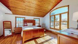 22735 Hickory Rd, Lanesboro, MN 55949 - bedroom featuring wood ceiling, lofted ceiling, dark wood-type flooring, and baseboards