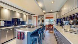 22735 Hickory Rd, Lanesboro, MN 55949 - kitchen featuring tasteful backsplash, a breakfast bar area, light countertops, a kitchen island, and recessed lighting