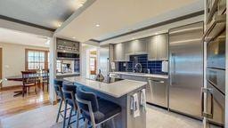 22735 Hickory Rd, Lanesboro, MN 55949 - kitchen featuring light countertops, a breakfast bar area, dishwasher, a center island, and black electric cooktop