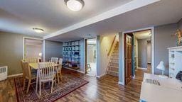 22735 Hickory Rd, Lanesboro, MN 55949 - dining room with baseboards, stairway, and wood finished floors