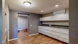 22735 Hickory Rd, Lanesboro, MN 55949 - kitchen with baseboards, wood finished floors, white cabinets, and recessed lighting