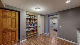 22735 Hickory Rd, Lanesboro, MN 55949 - interior space with a barn door, baseboards, and dark wood-type flooring