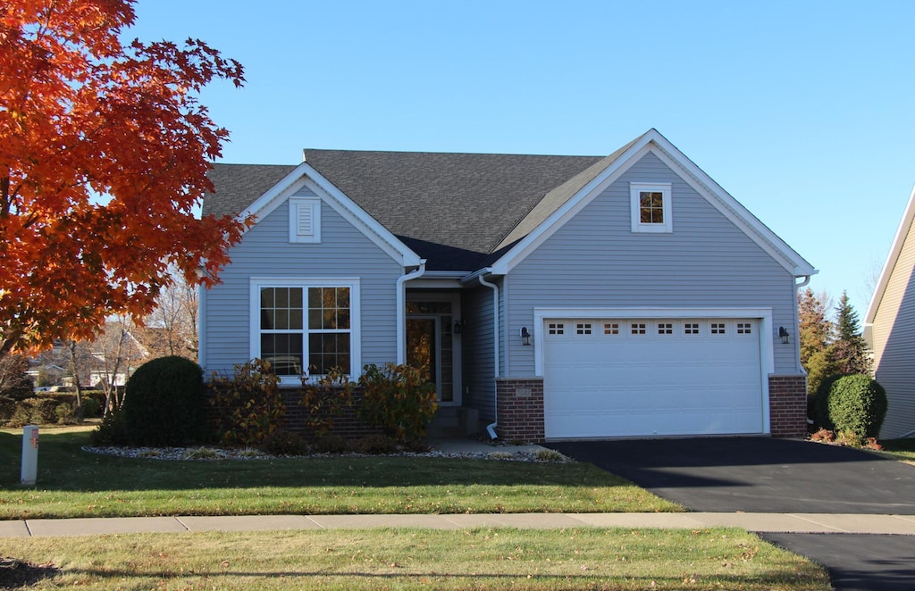 view of front of house featuring a front yard and a garage