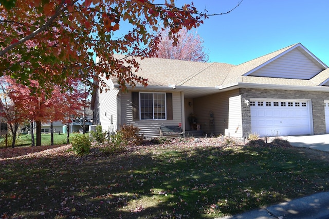 single story home featuring a garage and a front lawn