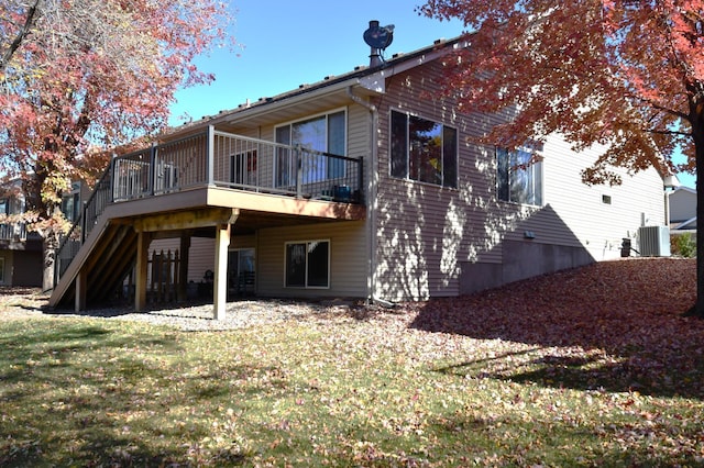 back of house featuring a yard, cooling unit, and a wooden deck