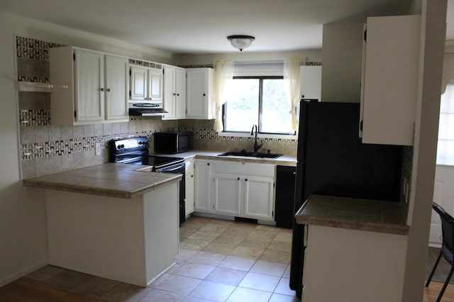 kitchen with white cabinetry, black appliances, sink, and backsplash