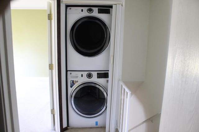 clothes washing area with stacked washer / drying machine