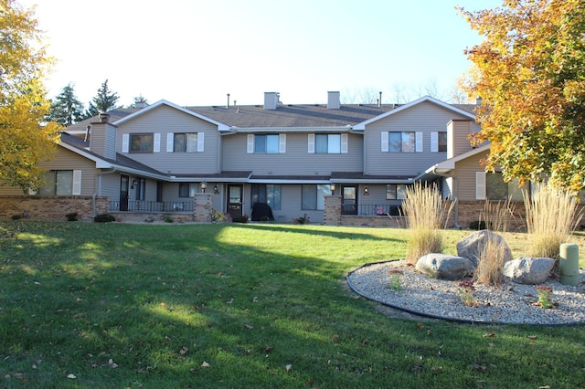 rear view of property with a yard