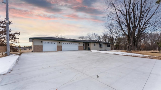 ranch-style home featuring an attached garage and brick siding