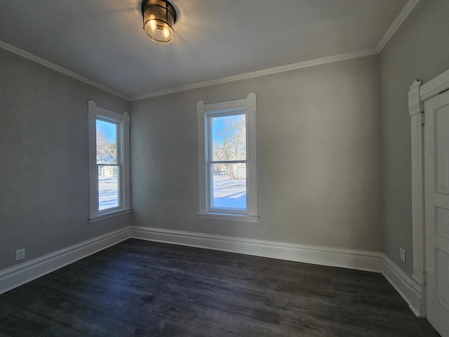 spare room featuring dark wood-type flooring, plenty of natural light, crown molding, and baseboards