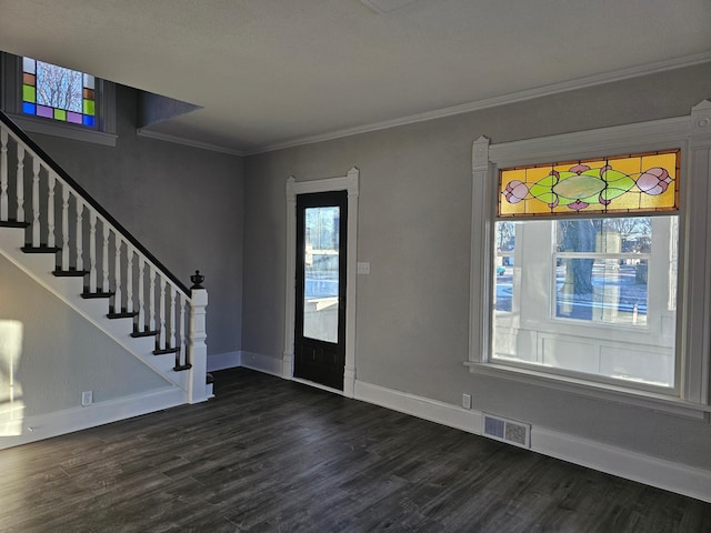 foyer entrance with visible vents, dark wood-style floors, stairway, crown molding, and baseboards