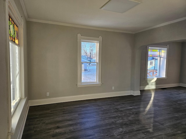 unfurnished room featuring visible vents, ornamental molding, baseboards, and dark wood-style flooring