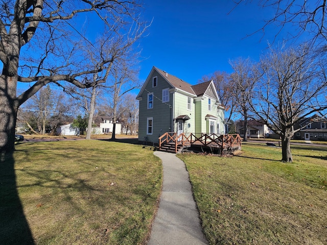 view of home's exterior featuring a lawn and a deck