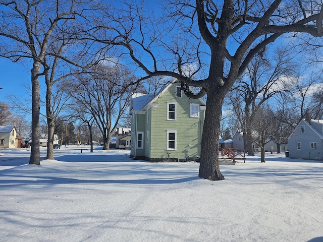 snow covered property featuring a residential view