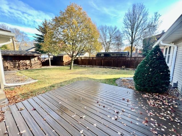 wooden deck with a lawn