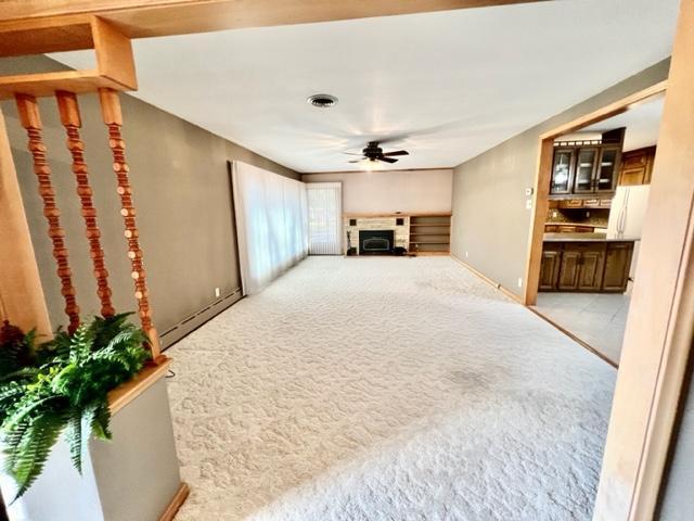 living room with light colored carpet and ceiling fan