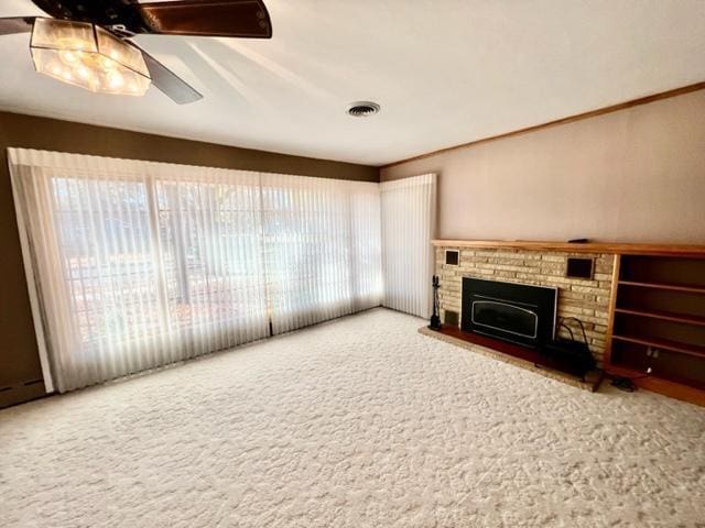 unfurnished living room featuring carpet flooring and ceiling fan