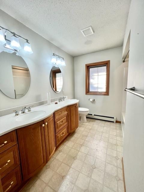 bathroom featuring toilet, baseboard heating, a washtub, vanity, and a textured ceiling